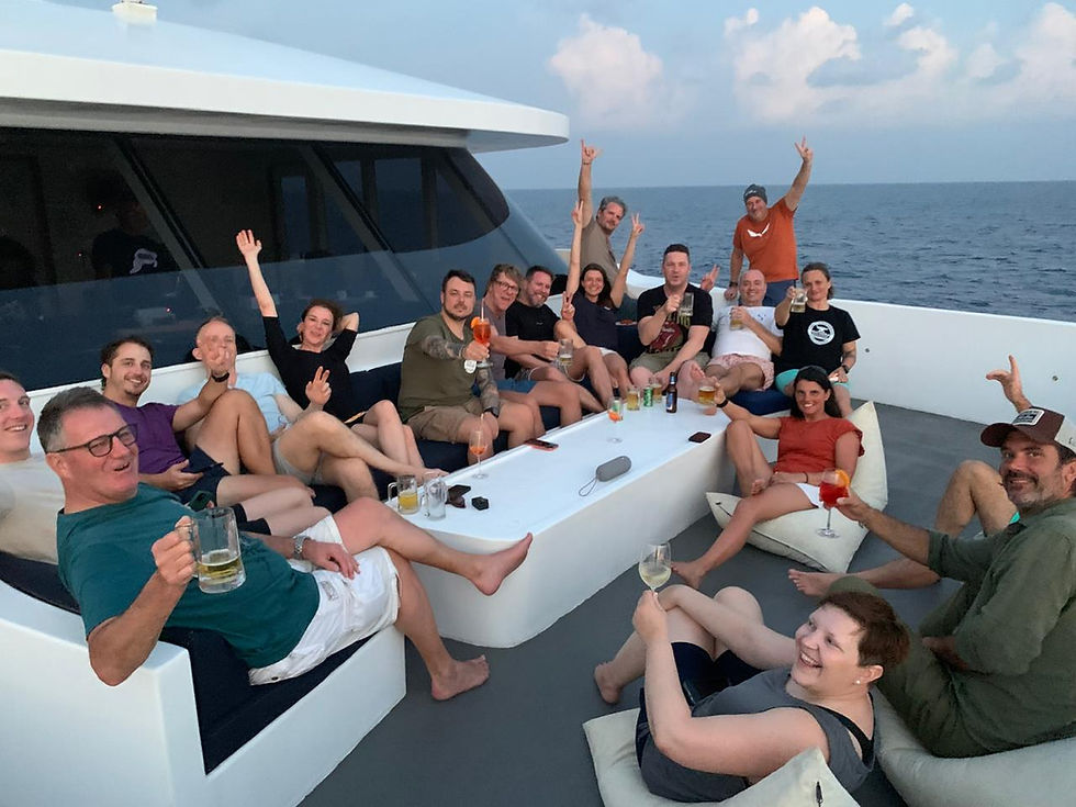 Guests enjoying sunset drinks on the deck of the EcoPro Seascape during a Maldives Deep South Liveaboard diving trip from Male to Gan