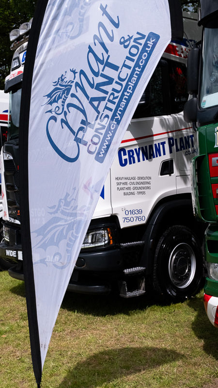 White feather flag for CRYNAANT PLANT HIRE & HAULAGE LTD. with truck.