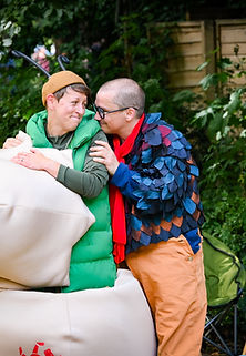 Two people dressed in colourful costumes as The Turkey and The Caterpillar in full flow of activitiy.