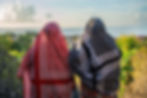 Deux femmes en vêtements traditionnels admirant la mer.
