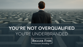 Back view of a man in a suit standing in front of a maze with the text “You’re Not Overqualified — You’re Underbranded” and Bigger Fish Executive Branding logo.