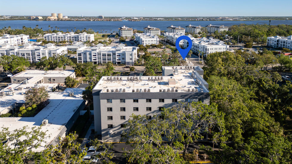 Aerial view of buildings near a waterfront.