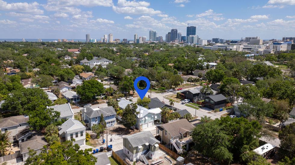 Aerial view of a neighborhood with city skyline.