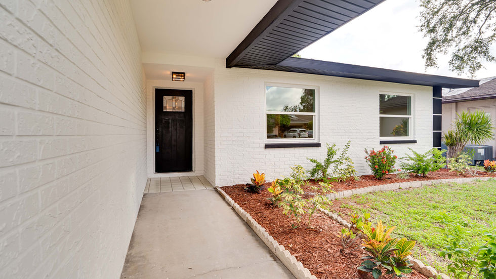 Enjoy the black lines of the exterior of this home splashing off of a white exterior paint