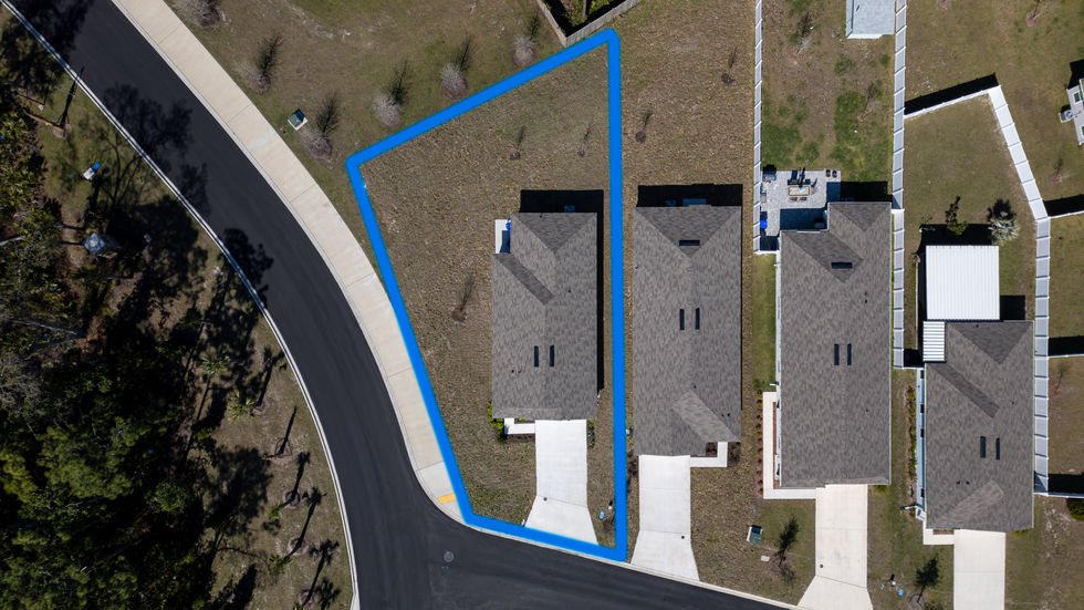 Aerial view of two houses with blue boundary line.