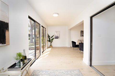 Bright, modern room with large windows and minimal decor.