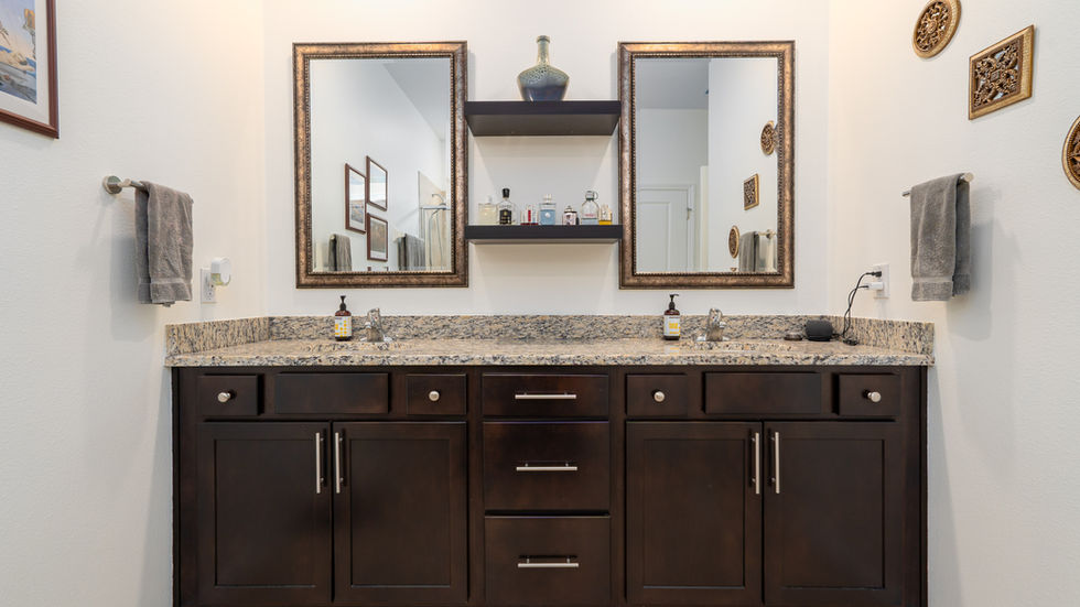 Modern bathroom vanity with dual mirrors and dark cabinets.