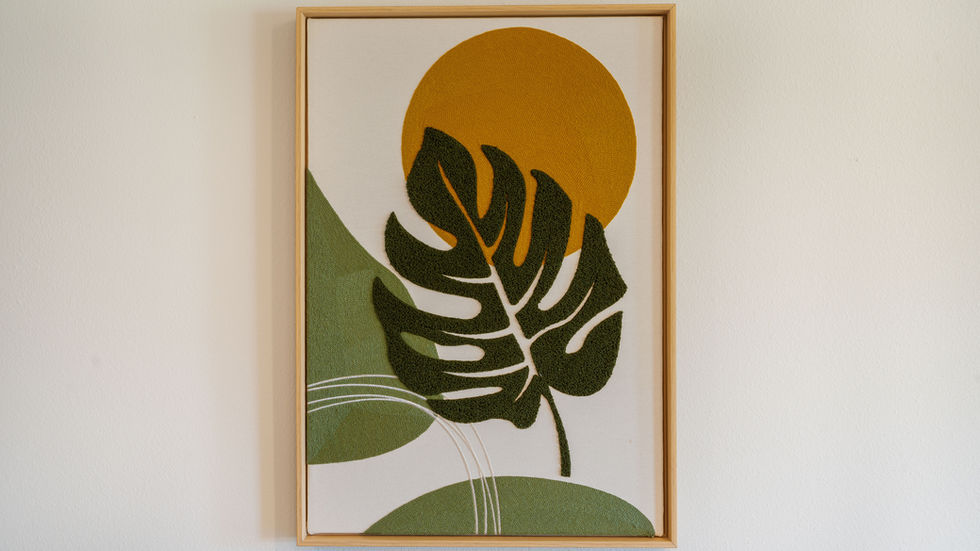 Abstract leaf art with sun, green and yellow tones.
