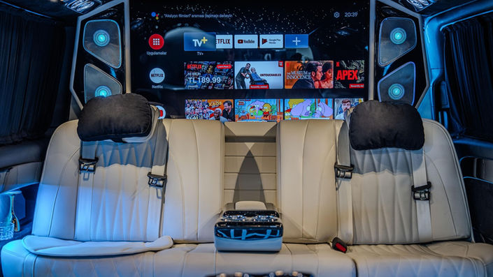 Rear entertainment screens in luxury Mercedes transfer cabin