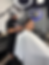 Skilled barber trimming hair with precision at Dom & Luigi's Barbershop.