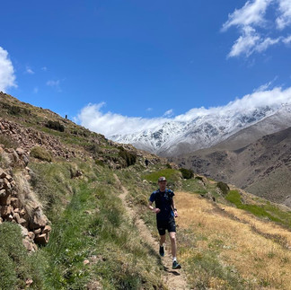 Runner navigating technical rocky terrain on the Toubkal trail circuit in Morocco