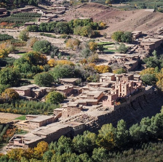 Traditional Amazigh village and green fields in Aït Bouguemez Valley during the Mount M’Goun trekking adventure in Morocco