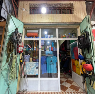 Lahcen’s mountain equipment rental shop in Imlil, run by an experienced Amazigh guide providing crampons, ice axes, and winter gear.
