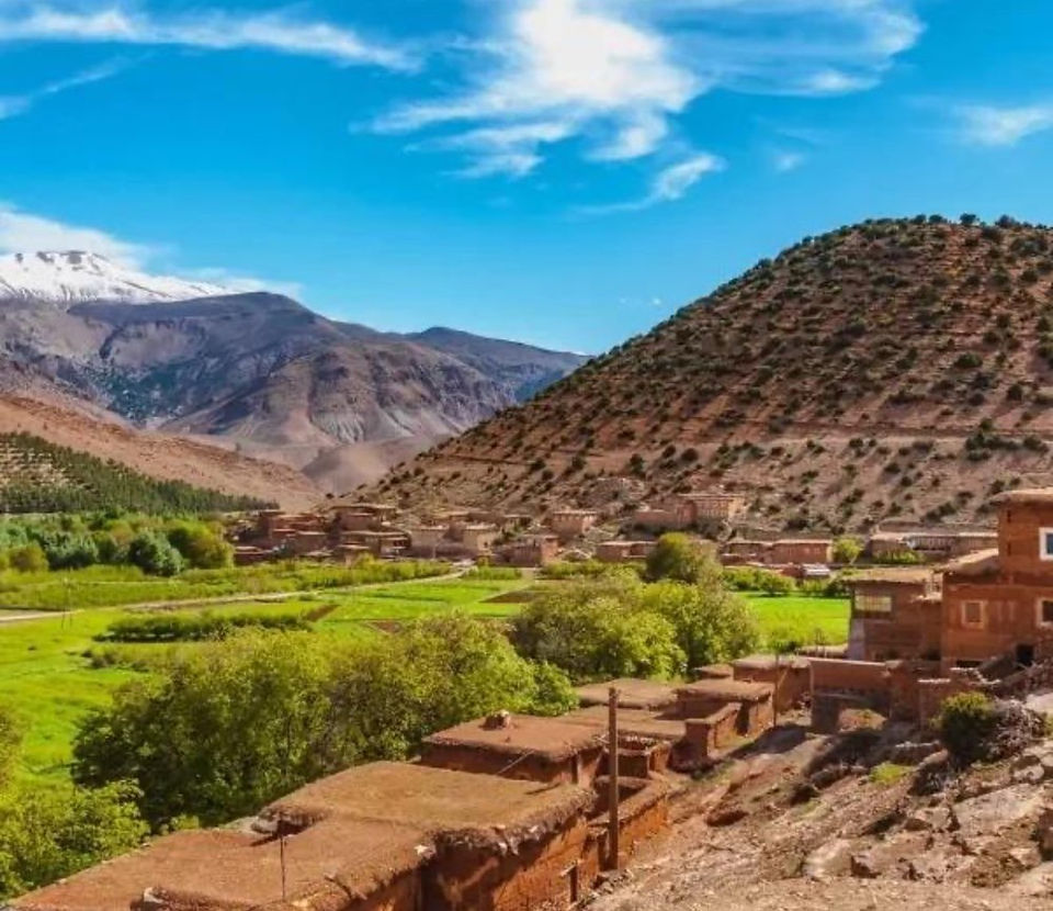 Panoramic view of Aït Bouguemez Valley with mud-brick Berber houses and fertile farmland in the High Atlas Mountains