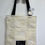 Miniature : Tote bag with black handles and Believe in your dreams tag.
