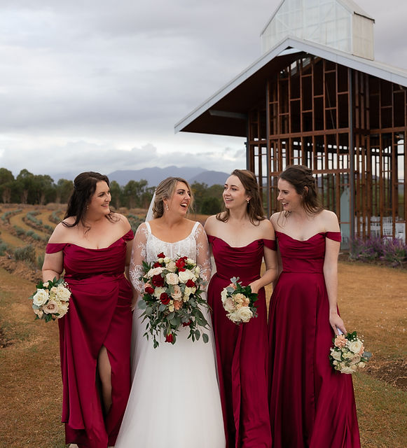 Bride and bridesmaids with burgundy, blush and ivory wedding bouquets