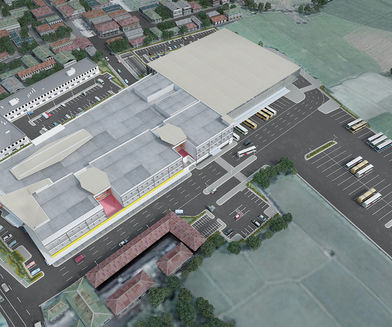 Aerial view of the Bataan Terminal and Convention Center showcasing its expansive layout, featuring a mix of commercial spaces, parking areas, and bus bays integrated into a surrounding urban and rural landscape.