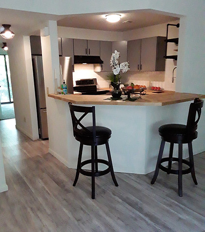 Refurbished and brightly lit kitchen with seating area