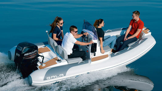 Four people riding in a rigid inflatable boat on the water