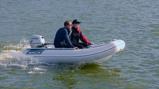 Two people riding in an ATLANTIS LITE inflatable boat