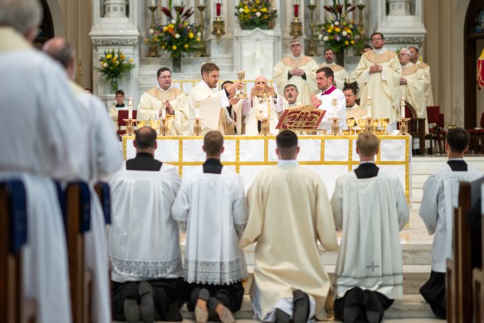 Archbishop Samuel Aquila elevates the Eucharist during the priestly ordination last weekend. (Photo by Daniel Petty/Denver Catholic)
