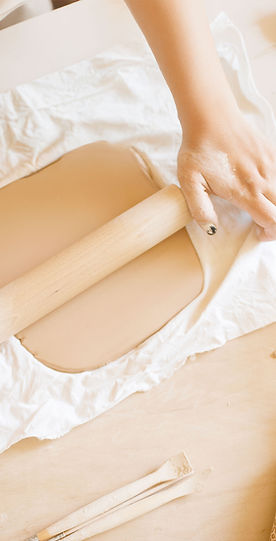 female-potter-roll-out-foarm-with-rolling-pin-pottery-workshop-woman-molding-working-mater