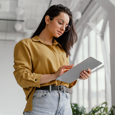 young-businesswoman-checking-her-tablet-with-copy-space_edited.jpg