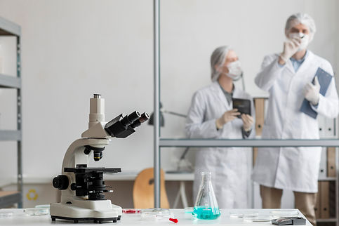two scientists writing on board medium-shot-scientists-discussing-lab.jpg