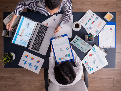 top-viewtop-view-manager-employee-doing-teamwork-business-office-looking-charts-laptop-dis