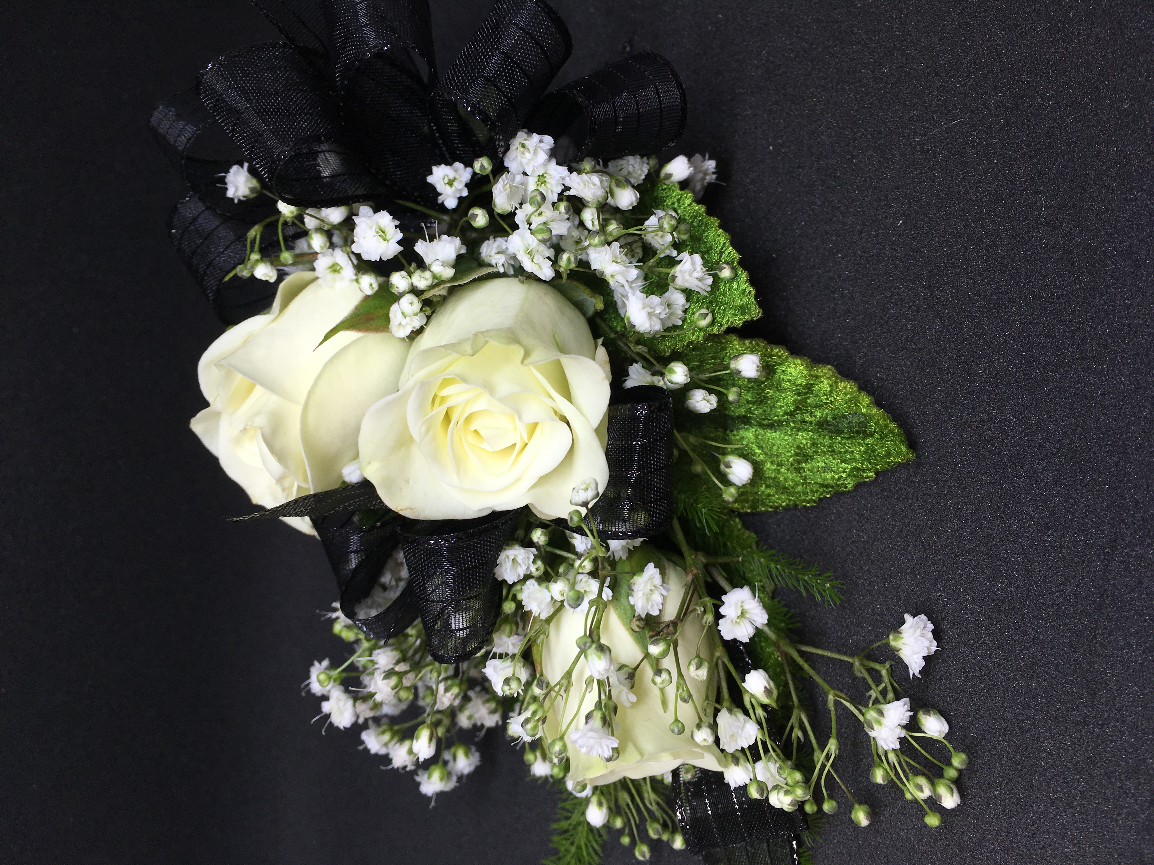 White roses and black ribbon corsage