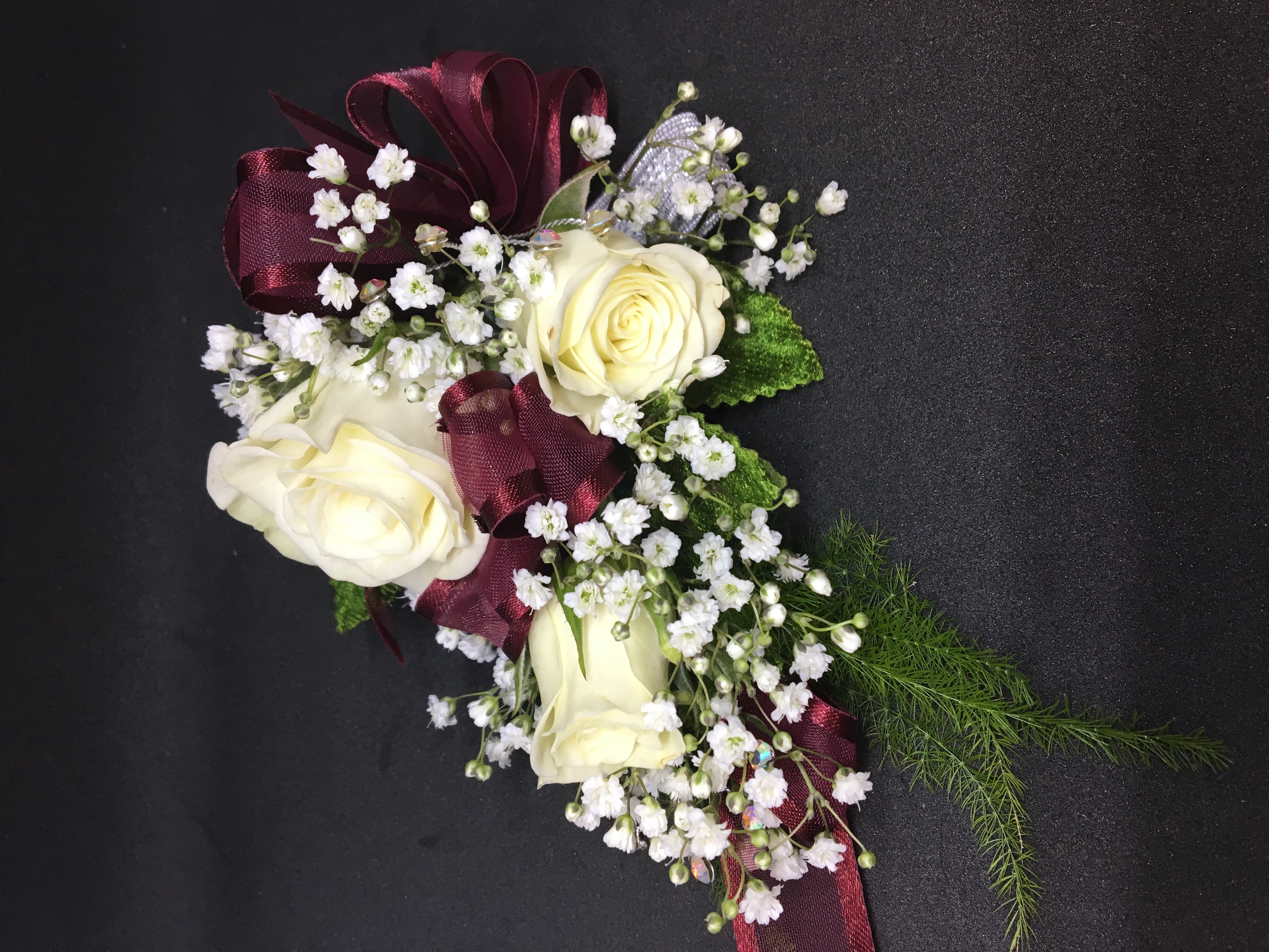 White spray rose & burgundy corsage