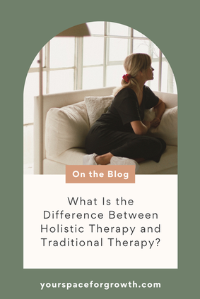 A woman sits thoughtfully on a cozy white sofa near large windows, illustrating a calm and reflective mood for a blog post about the difference between holistic therapy and traditional therapy.