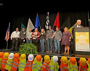 Congratulations to Safety Group Leader at Subaru of Indiana Automotive, Inc. John Sanders and EHS Lead at GE Aviation Brandy Marsh for receiving an Everyday Safety Hero Award at the annual Governor’s Workplace Safety Awards Luncheon in Indianapolis last week. The Everyday Safety Hero award recognizes individuals who have championed workplace safety and health excellence in their respective workplaces. It was developed to acknowledge and recognize the contributions, participation, and impact that a front-line employee plays in workplace safety and health excellence.
Sanders was recognized for contributions made in his volunteer position as president of the Greater Lafayette Area Safety Council (GLASC) since 2012. GLASC provides access to local monthly networking and educational speakers.
During his tenure, GLASC has grown its membership to over 60 companies with approximately 40 attendees at monthly meetings. Additionally, in 2022, he led an effort to donate PPE to the Greater Lafayette Career Academy, stock hats for children in the Bauer Community Center after-school program, and monetary donations to several other local nonprofits.
Marsh was recognized for her vested time in developing the EHS program and building up the knowledge and confidence of those around her including technicians as well as other staff including the EHS specialist on-site. She has been able to build a team that is able to help push EHS forward in leading the site to a safer work environment.
Marsh led a team last year to the Ergo Cup, won a trophy and a few technicians that went with her learned quite a bit at the conference coming back ready to help improve the site. She has started the ergo committee as well as helped jump-start the on-site wellness program. She has also taken on the challenge of taking the site to the next level by working towards VPP certification for the site.
COMMUNITY CONTRIBUTIONS!
The Greater Lafayette Area Safety Council and Ejendals (https://www.ejendals.com/) joined forces to distribute Personal Protective Equipment to the Greater Lafayette Career Academy at 2201 S 18th St, Lafayette, IN (https://www.glcareeracademy.com/) (@GLCareerAcademy) students on march 7th. The PPE will be distributed to different classes within the Academy, specifically the welding and construction classes. Thank you to Ejendals for your generous donation in helping keep our young adults’ safe while at school/ work.”
March 2023- Fall Protection (Tool – Leading Edge & Sharp Edge Hazards)
Thanks to Conagra Brands, Shelley Wuerthner for sponsoring our lunch!
Our Presenter: Sampson Briggs from 3M
In this session, we learned about various resources to check for hazards that affect fall protection equipment, and a variety of tethering accessories to anker hand tools and power tools, Sampson brought many examples of equipment we can implement in our fall protection programs.
On behalf of the GLASC Executive Board, we appreciate all the participants in our goal of making safer workplaces!
