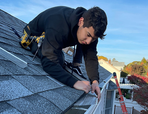 Professional gutter guard installation on a residential roof in Atlanta GA by REM Property Service