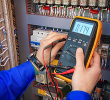 Electrical Engineer adjusts electrical e