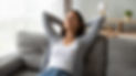 Relaxed serene pretty young woman feel fatigue lounge on comfortable sofa hands behind hea