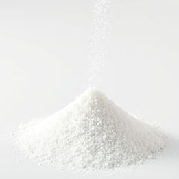 pouring crystalline powder, like salt, into a small pyramid pile of crystalline powder sma