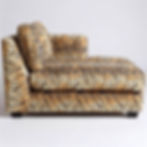 Thumbnail: Side view of a vibrant tiger-print chaise lounge with a left armrest and an angled back cushion.