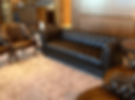 Reupholstered brown leather couch and chairs in a living room. The furniture has a classic style wit
