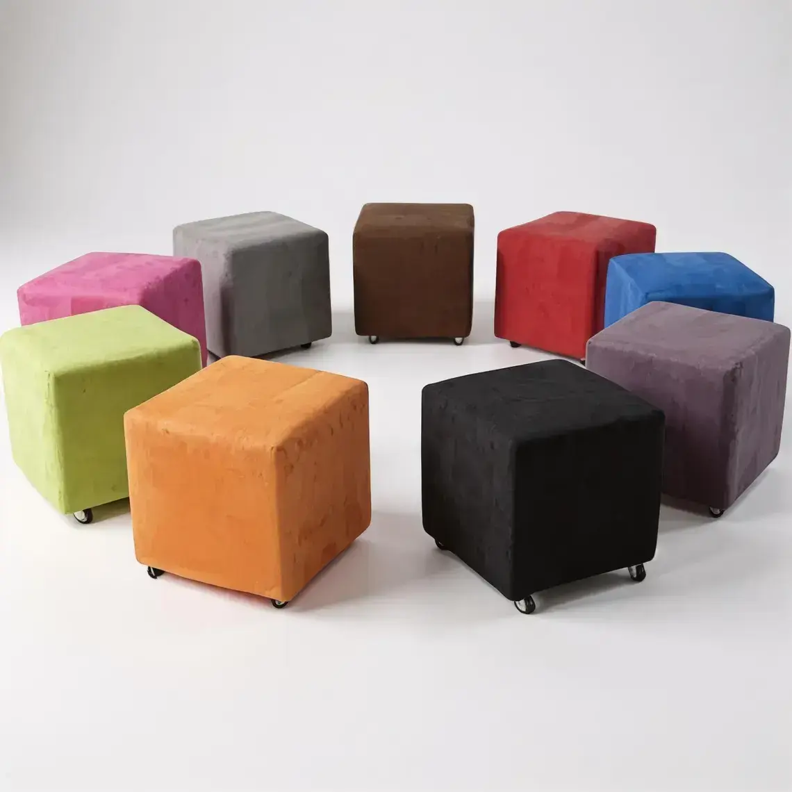 Nine colorful cube ottomans with wheels, in various shades including pink, gray, brown, red, blue, purple, orange, black, and