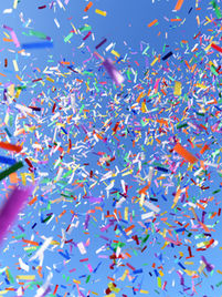 A drone drops colorful confetti from the sky, adding a festive touch to a celebration with balloons, candies, and small gifts for a lively atmosphere.