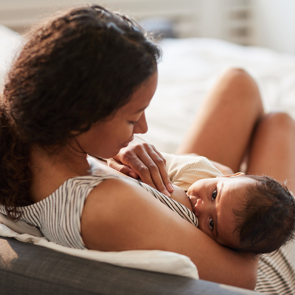 Mother breastfeeding her baby, showing natural postpartum body changes after pregnancy and breastfeeding