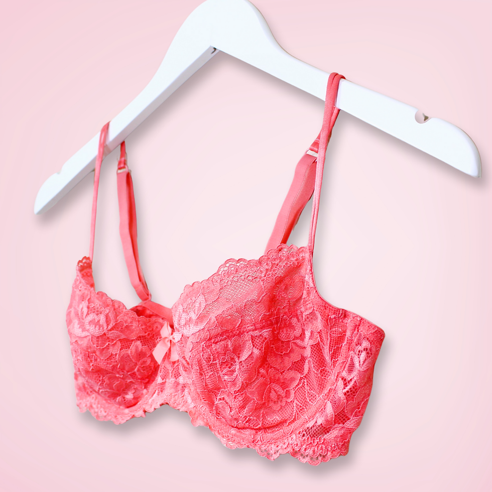 Right angle of coral lace bra showing split front strap and balconette shape