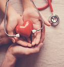hands-holding-red-heart-with-stethoscope