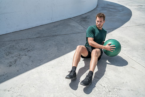 Medicine ball exercise russian twist man. Abs workout - fitness athlete working out doing
