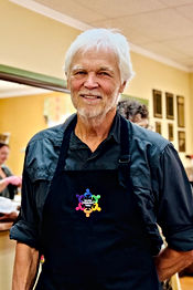 Smiling man wearing a Saluda Center apron