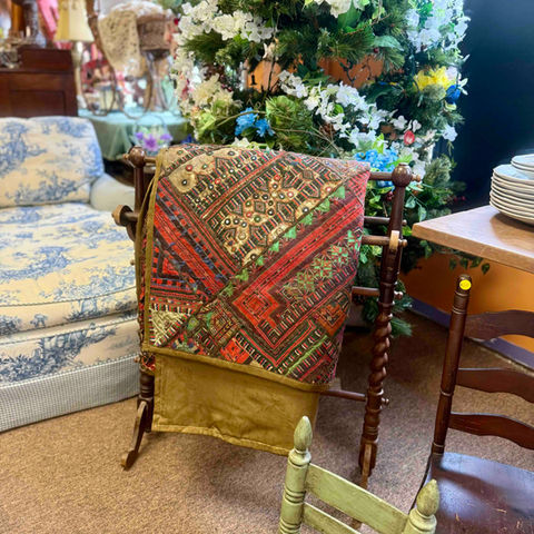 Vintage quilt displayed on wooden rack
