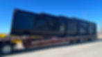 Black Roll Off Dumpsters Transporting