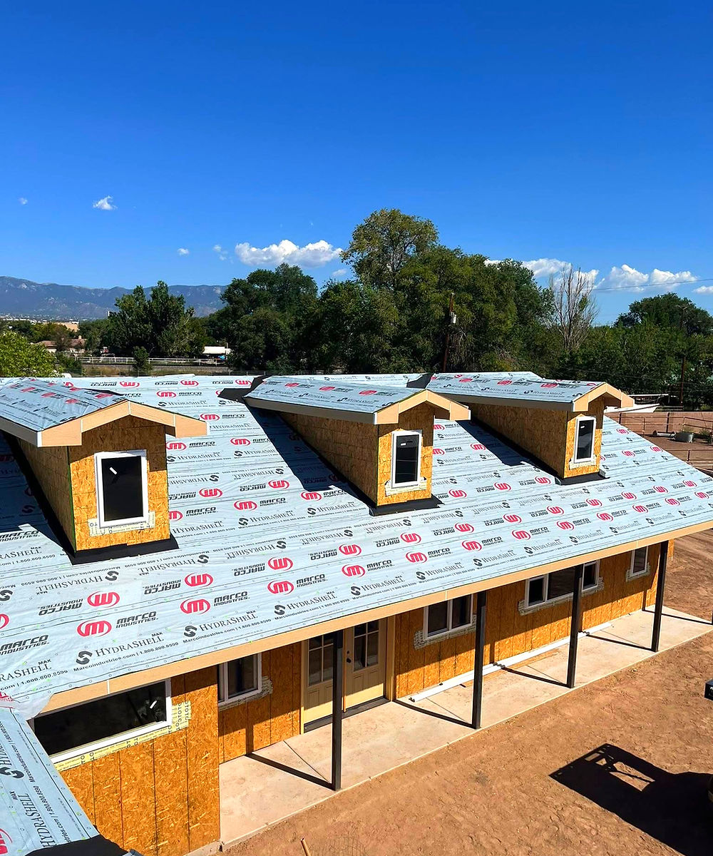 House under construction with dormer windows