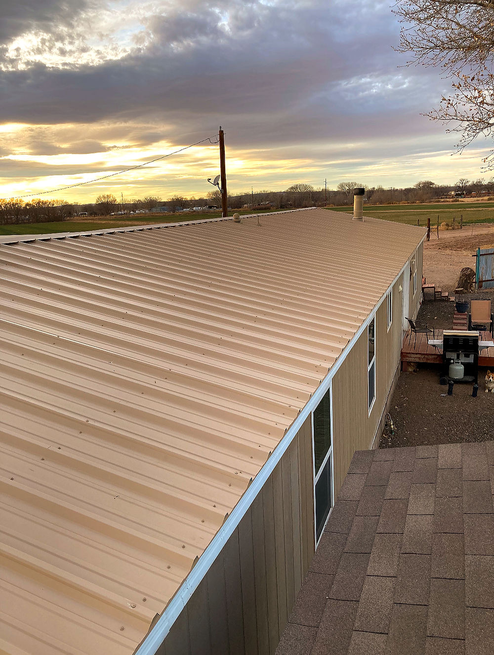 Tan corrugated metal roof at sunset